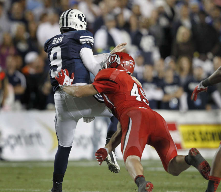 Brigham Young Cougars quarterback Jake Heaps (9) is hurried by Utah Utes linebacker Trevor Reilly (49) (Tom Smart, Deseret News)