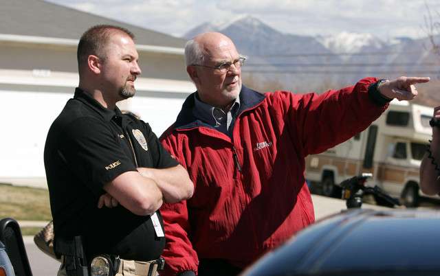 Neighbor Ron Webb talks with West Jordan Police as they investigate a homocide and possible suicide at a residence in West Jordan Wednesday, March 21, 2012. A mother shot her 18 year daughter and then turned the gun on herself. (Photo: Jeffrey D. Allred, Deseret News)