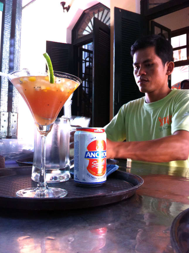 A teacher and student at Romdeng restaurant work side by side during preparations for the lunch rush in Phnom Penh, Cambodia.