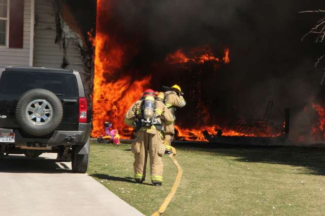 Flames engulf an American Fork home where two American Fork city workers Randall Honey and Jon Varney pulled a mother and daughter from their burning house Monday, April 2, 2012. (Photo: Josh Christensen, American Fork Police Department)