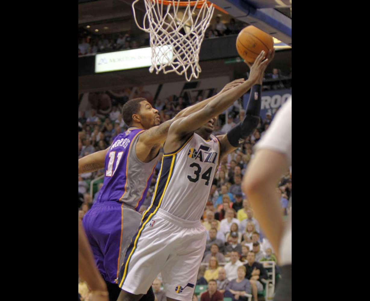 Utah's CJ Miles drives past Sun's Markieff Morris and is fouled as the Utah Jazz are defeated by the Phoenix Suns 107-105 as they play NBA basketball Wednesday, April 4, 2012, in Salt Lake City, Utah. (Tom Smart, Deseret News)