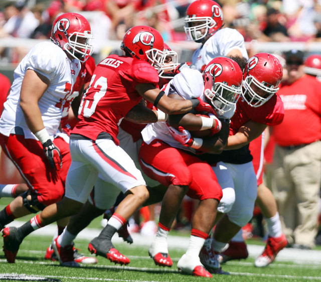 White's #13 Kelvin York is gang tackled during the Utah football Red & White Spring Game Saturday, April 21, 2012 at Rice Eccles Stadium. (Scott G Winterton, Deseret News)
