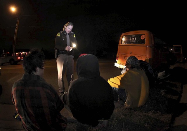 Trooper Lisa Steed talks to teens stopped for a suspected DUI in Davis County Feb. 12, 2010. The motorist was arrested for driving under the influence of marijuana. (Photo: Michael Brandy, Deseret News)