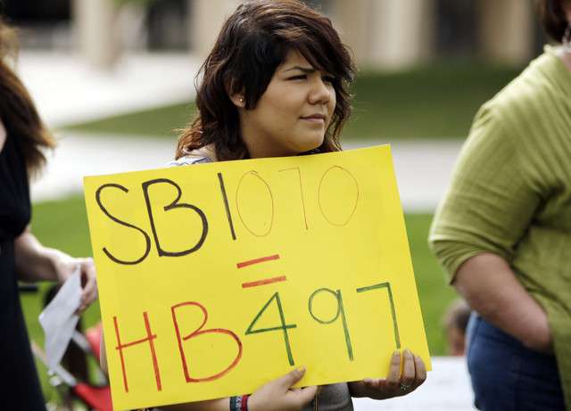 Itza Hernandez holds a sign asSalt Lake Dream Team and Peaceful Uprising members gather during a rally at the Salt Lake City Library in Salt Lake City Wednesday, April 25, 2012. Today the U.S. Supreme Court heard oral argument on Arizona's immigration law, Senate Bill 1070. (Photo: Jeffrey D. Allred, Deseret News)