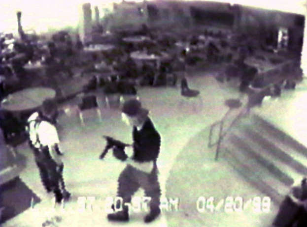 FILE - In this April 20, 1999 file photo Eric Harris, left, and Dylan Klebold, carrying a TEC-9 semi-automatic pistol, are seen in a photo made from a security camera image in the cafeteria at Columbine High School, in Littleton, Colo., during their shooting rampage which killed a teacher and 12 students. (AP Photo/Jefferson County Sheriff's Department/File)