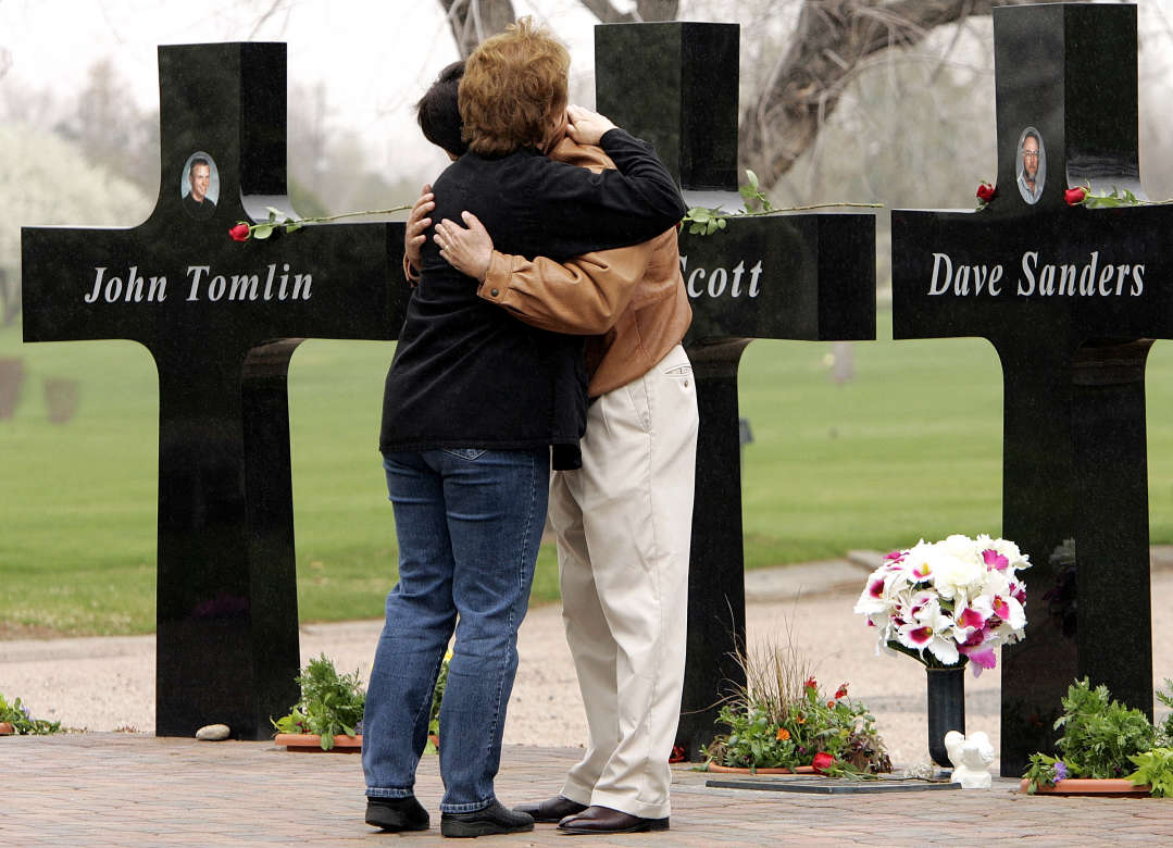 Brad and Misty Bernall hug as they visit a memorial in Littleton, Colo., Wednesday, April 20, 2005, for their daughter, Cassie, and the twelve other students and a teacher who were killed six years ago in the massacre at Columbine High School. (AP Photo/Ed Andrieski)