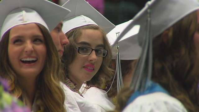 Amanda Peterson, center, sits with classmates
during graduation ceremonies at Provo High
School Thursday, May 24, 2012. After being
severely injured by an abuser as a child, she
was not expected to be able to walk again, let
alone graduate from high school.