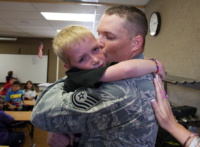 Timothy Mecham hugs his father as Tech. Sgt. Les Davenport III, as he arrives and surprises his chiildren at Vae View Elementary in Layton, Tuesday, May 29, 2012. Davenport was returning home from Korea on mid-tour leave.