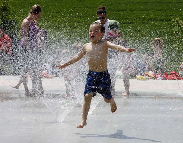 Children play at a new splash pad in Cottonwood Heights, Monday, June 4, 2012.