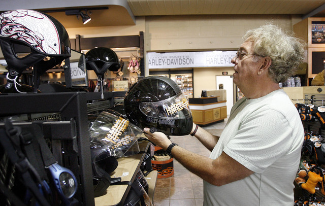 Dennis Clark looks at a helmet at Harley-Davidson in South Salt Lake, Tuesday, June 5, 2012. He says he wears a helmet for safety. Clark states, "You could break an arm and get it fixed. You break a head and you're dead."