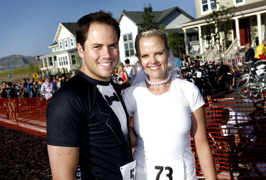 Colby Beal and Shannon Beasley wear a tuxedo t-
shirt and a veil for the Daybreak Triathlon in
South Jordan.