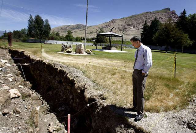 Jay Aguilar, City Planner for Willard, looks down at a sewer line trench that was dug on the property of the Pioneer Cemetery in Willard on Wednesday, June 12, 2012.