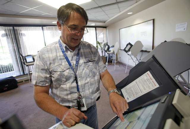 William Bartsch votes early at the Salt Lake County Clerk's Office in Salt Lake City on Monday, June 18, 2012.