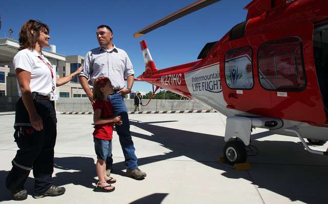 Mike Tillack, center, the first trauma patient transported on a new Agusta Grand, talks with nurse Andrea Clement, left. Mike's daughter Stevie Tillack is below. (Photo: Ravell Call, Deseret News)
