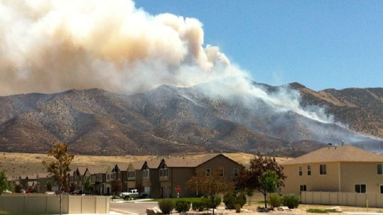 Evacuees return home as Eagle Mountain fire continues to rage