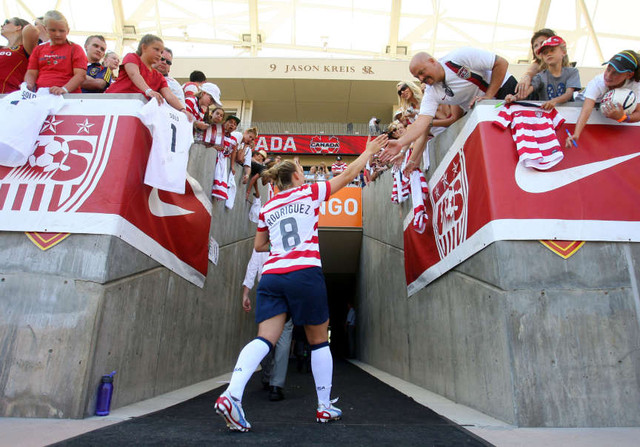 USA's #8 Amy Rodriguez slaps hands of fans as she leave the pitch. USA women take on Canada in a pre olympics match Saturday, June 30, 2012 at Rio Tinto stadium. USA won 2-1. (Scott G Winterton, Deseret News)