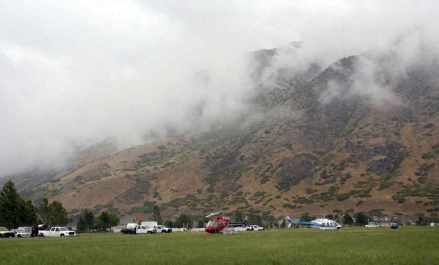 Helicopters are staged at the helibase during 
rain and bad visibility while trying to fight 
the Quail Fire in Alpine.