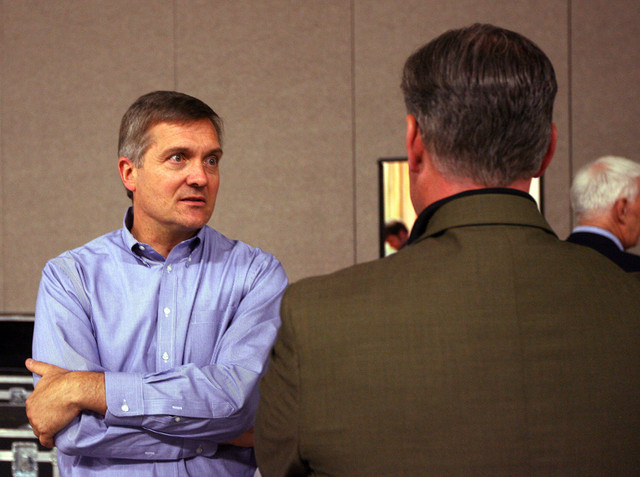 Rep. Jim Matheson talks with Salt Lake County Mayor Peter Corroon during the state Democratic convention in Salt Lake City April 21, 2012.