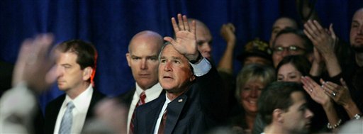 President Bush, center, waves goodbye after addressing the American Legion national convention Thursday, Aug. 31, 2006, in Salt Lake City. (AP Photo/Douglas C. Pizac)