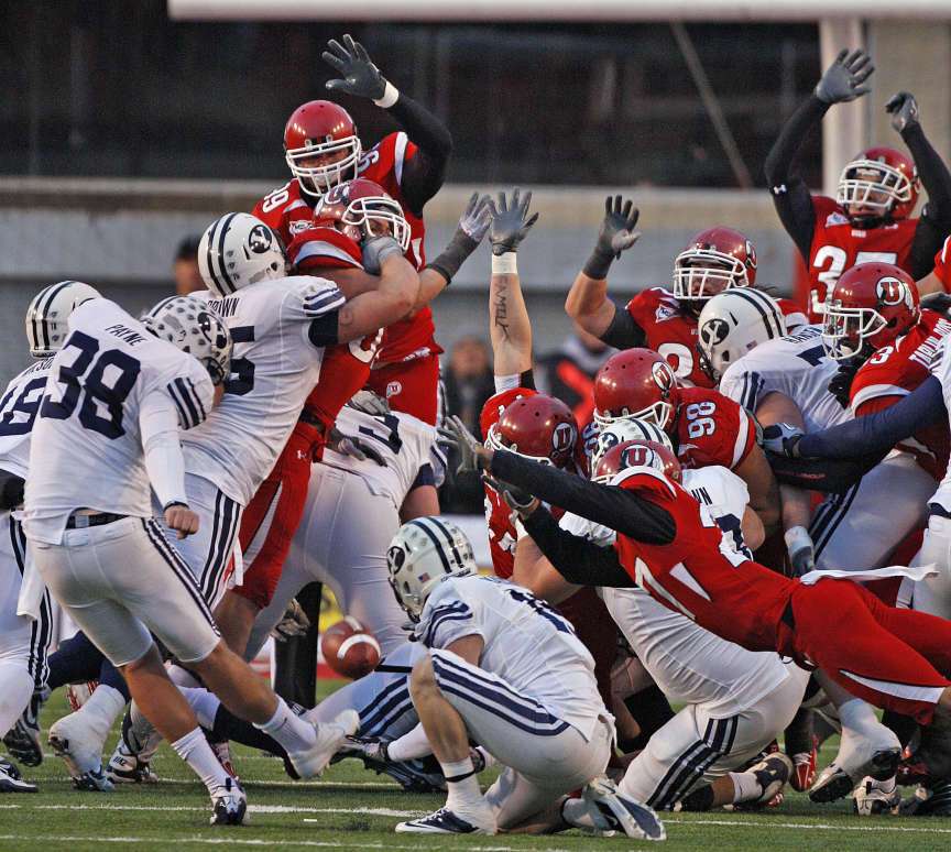 Utah's Brandon Burton (lower right) blocks BYU's Mitch Payne's field goal attempt in the final second as the University of Utah defeats Brigham Young University 17-16 in MWC football Saturday, Nov. 27, 2010, in West jordan, Utah. (Tom Smart, Deseret News)