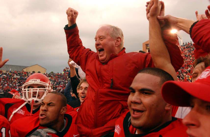 Utah head coach Ron McBride is hoisted to the palyers shoulders as the team celebrates after Utah beat BYU 13-6 at Rice-Eccles Stadium Saturday, November 23, 2002. (Jason Olson, Deseret News)
