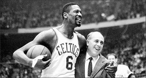 In this Dec. 12, 1964 file photo, the Boston Celtics' Bill Russell, left, is congratulated by coach Arnold "Red" Auerbach after scoring his 10,000th career point during a basketball game against the Baltimore Bullets at the Boston Garden. (AP)