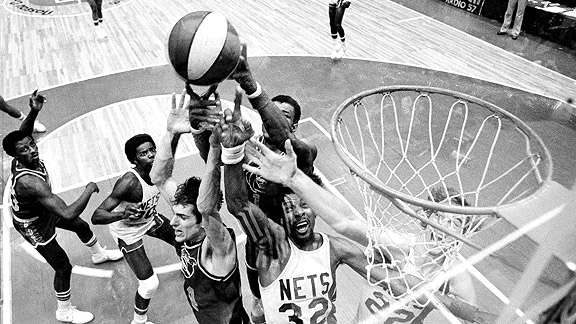 The New York Nets' Julius Erving battles for the ball against the Nuggets during the final ABA game. AP Photo/Richard Drew