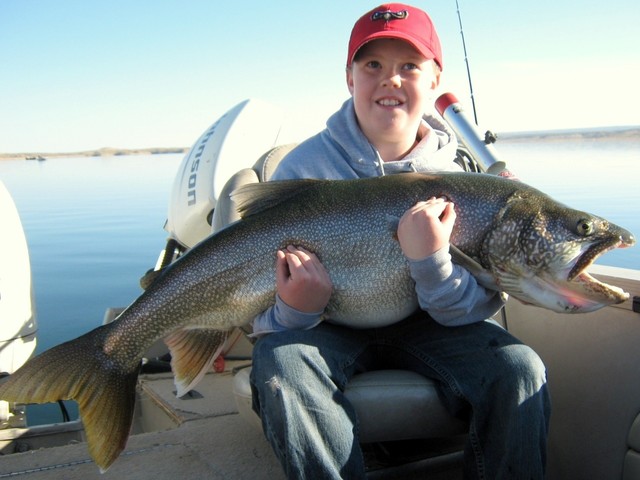 A young angler poses with a trophy lake trout
caught from Flaming Gorge Reservoir in
northeastern Utah. (Photo: Ashley Bonser)
