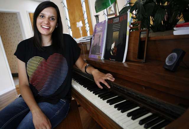 Anisa Mughal poses for a photo by the piano in
her home in Salt Lake City on Friday, July 13,
2012. (Photo: Kristin Murphy, Deseret News)