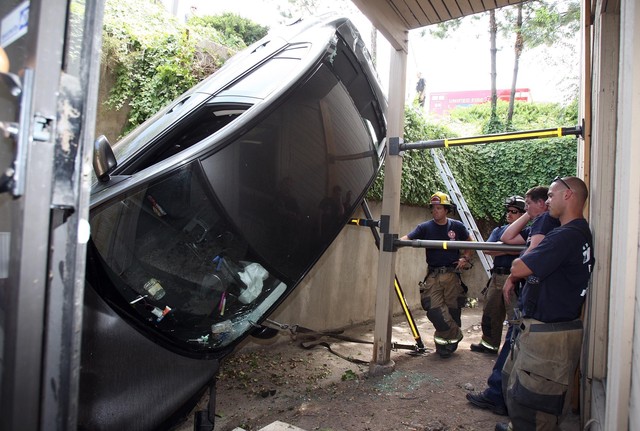 Unified Fire Authority investigate the scene
after a car went off a parking structure in
Cottonwood Heights Monday, July 23, 2012. There
were only minor injuries. (Photo: Ravell Call,
Deseret News)