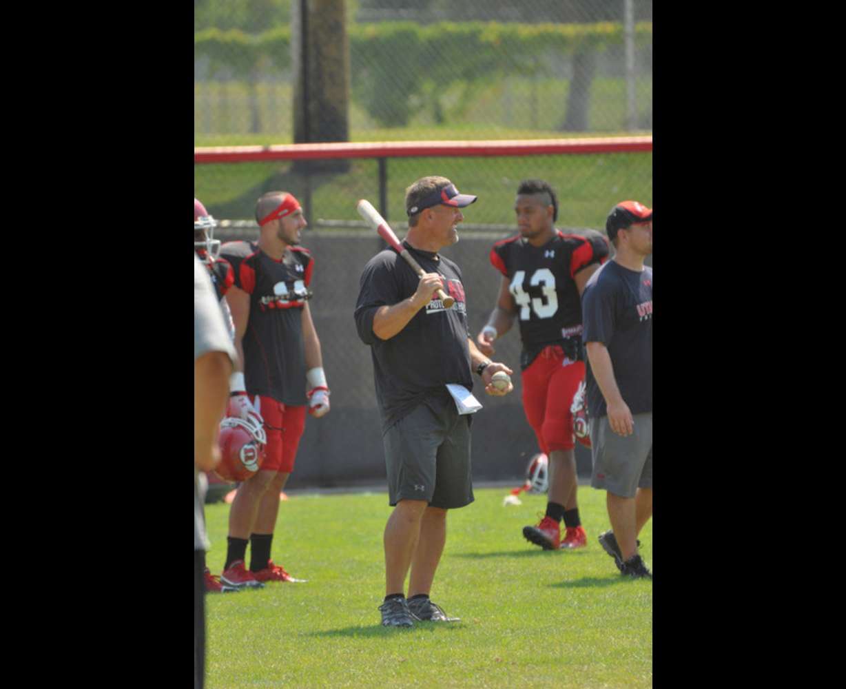 The Utes had a little fun after practice Tuesday. Since they are practicing on the baseball field during camp, they decided to channel their inner baseball player with a pop fly competition. Hitting was head coach Kyle Whittingham. Photo: Brooke Frederickson, Utah Associate Director of Communications