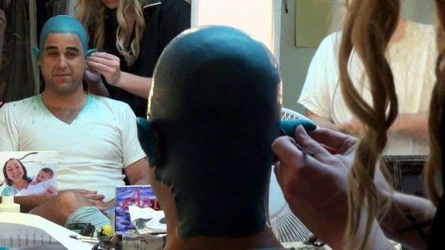 Makeup artists work to tranform Edward Juvier into the role of the Genie in Tuachan's production of "Aladdin the New Stage Musical." The process takes over an hour, Juvier said.