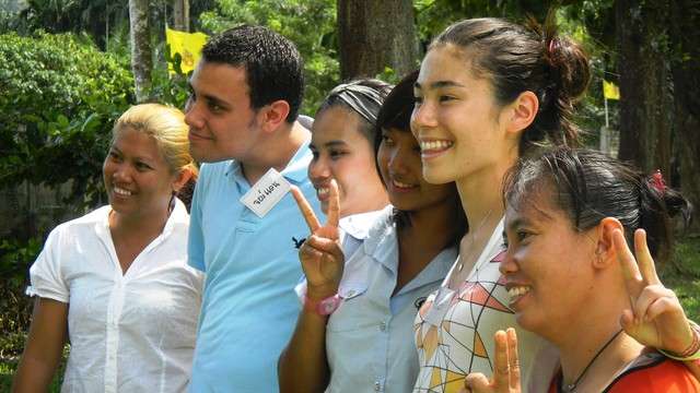 Jordan Nielson, 23, and Sierra Schlag, 16, pose for pictures alongside Thai students and teachers. (Sarah Dallof, KSL News)