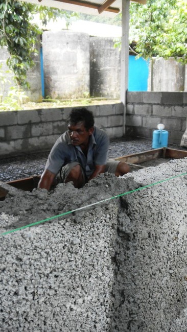 Bung Jedhun, 51, works on the chicken coop at Ban Tham Thong Lang School. Jedhun, the manager of a construction company, is volunteering his time to build the coop and a small fish farm. (Sarah Dallof, KSL News)