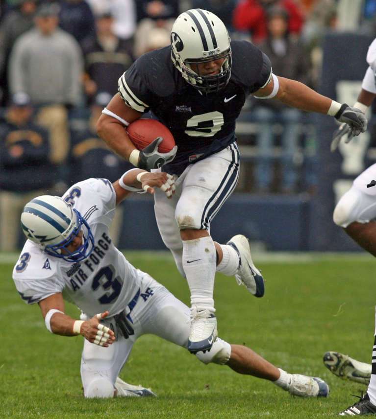 BYU's Naufahu Tahi (3) leaps over Air Force's Nathan Smith (3) as BYU faces Air Force in Mountain West football action at Lavell Edwards Stadium in Provo Saturday, October 29, 2005. Photo by Jason Olson, Deseret News