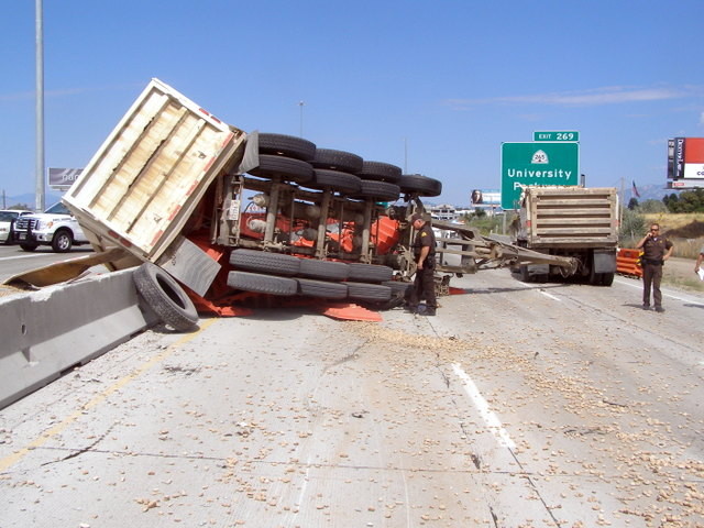 Rolled dump truck shuts down I-15 on Orem for hours