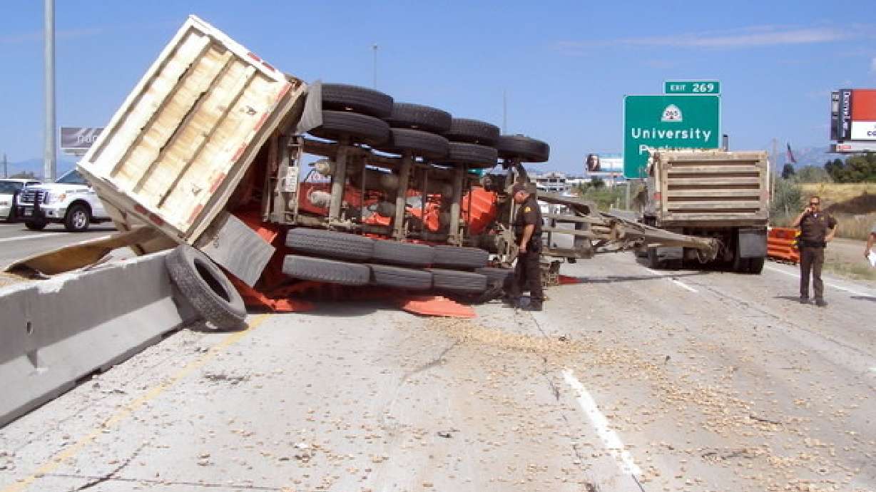 Rolled dump truck shuts down I-15 on Orem for hours
