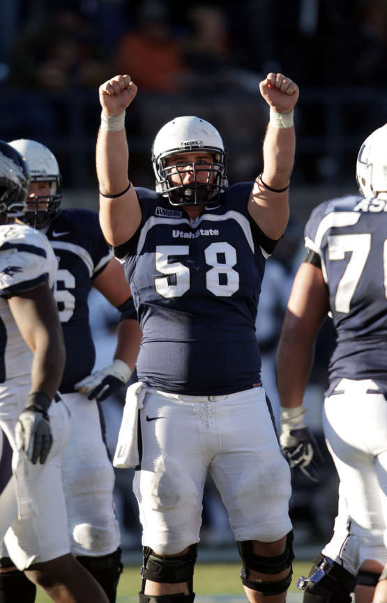 Utah State Aggies center Tyler Larsen (58) celebrates getting a first down and running out the clock to beating Nevada in Logan Saturday, Nov. 26, 2011. (Jeffrey D. Allred, Deseret News)