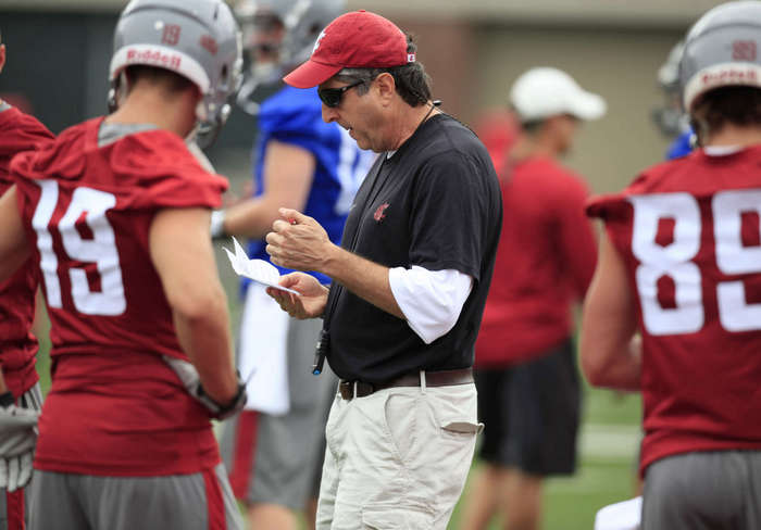 Washington State head coach Mike Leach checks his plan during the opening day of NCAA college football practice. (AP Photo/Moscow-Pullman Daily News, Dean Hare)