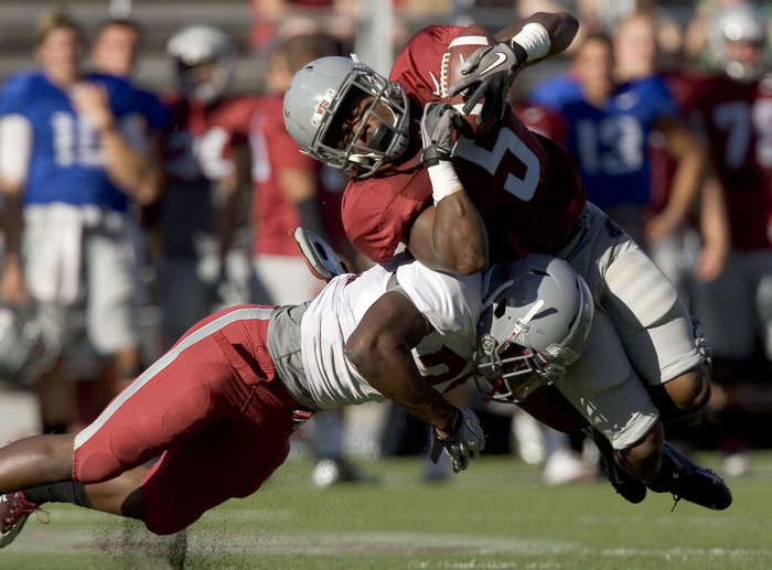 Washington State linebacker Eric Oertel (21) tackles running back Rickey Galvin (5) during a scrimmage at Martin Stadium in Pullman, Wash. (AP Photo/Moscow-Pullman Daily News, Dean Hare)