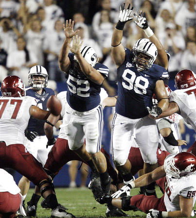 Brigham Young Cougars defensive lineman Russell Tialavea (52) and Brigham Young Cougars defensive lineman Romney Fuga (98) try to block a field gaol attempt against Washington State. (Jeffrey D. Allred, Deseret News)