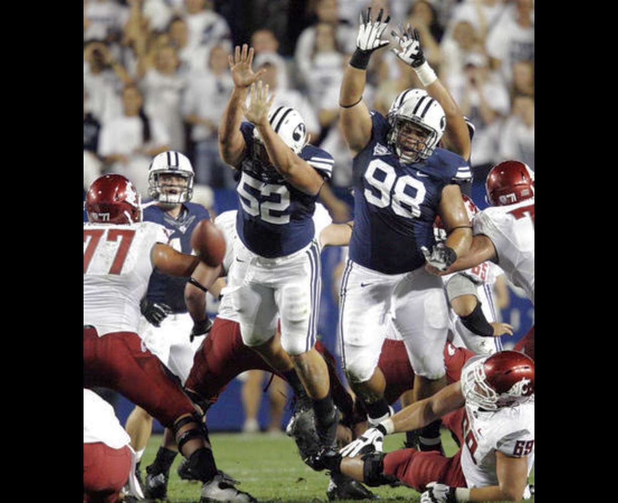 Brigham Young Cougars defensive lineman Russell Tialavea (52) and Brigham Young Cougars defensive lineman Romney Fuga (98) try to block a field gaol attempt against Washington State. (Jeffrey D. Allred, Deseret News)