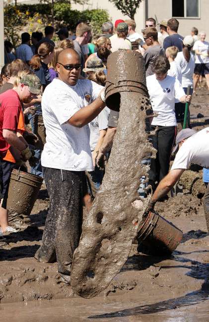 Volunteers help Saratoga Springs flooding victims remove mud and water from their homes in Saratoga Springs Sunday, Sept. 2, 2012.