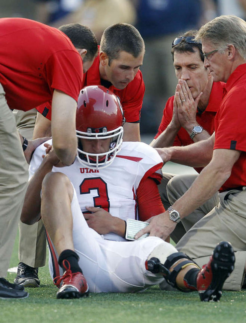 Jordan Wynn gets attended to by Utah's medical staff during the Utah State game in Logan (Jeffrey D. Allred, Deseret News)