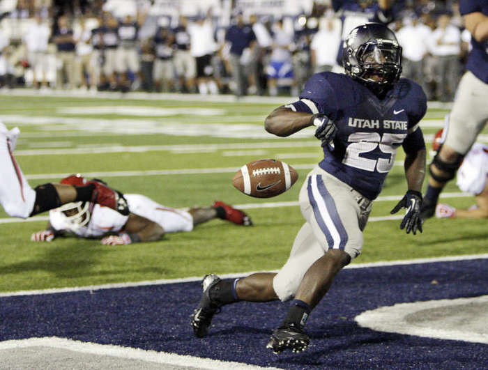 Utah State Aggies running back Kerwynn Williams (25) scores in overtime against the Utah Utes. (Jeffrey D. Allred/Deseret News)