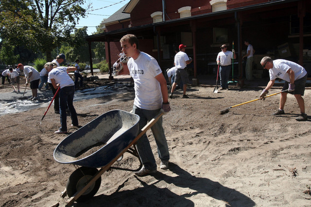 Seth Frischknecht moves a wheelbarrow while volunteering at the Pioneer Craft House during the United Way Day of Caring in Salt Lake City on Sept. 13, 2012. More employees are demanding charitable work be a part of their employer's structure. 