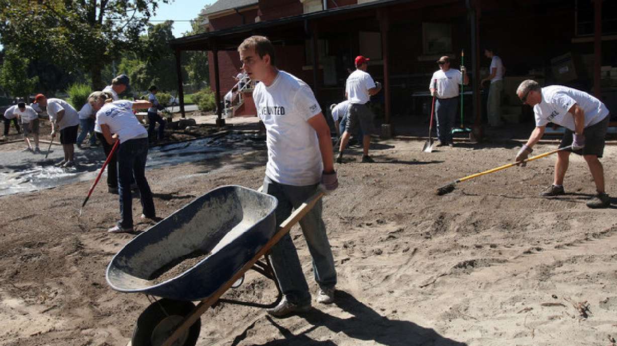 Seth Frischknecht moves a wheelbarrow while volunteering at the Pioneer Craft House during the United Way Day of Caring in Salt Lake City on Sept. 13, 2012. More employees are demanding charitable work be a part of their employer's structure.
