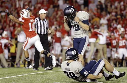 Wisconsin's Devin Smith (10) reacts after Utah State kicker Josh Thompson (19) missed a field goal attempt in the final seconds of an NCAA college football game Saturday, Sept. 15, 2012, in Madison, Wis. Wisconsin won 16-14. (AP Photo/Morry Gash)