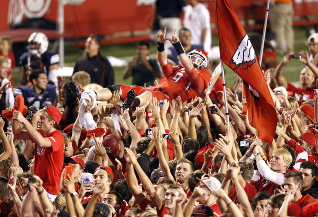 Fans storm the field as the University of Utah defeats BYU 24-21 (Tom Smart, Deseret News)