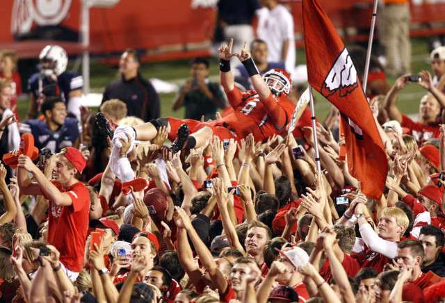 Fans storm the field as the University of Utah defeats BYU 24-21 (Tom Smart, Deseret News)
